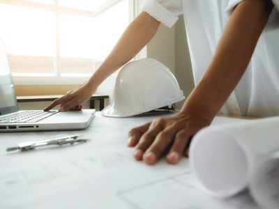 hands-engineer-working-blueprint-construction-concept-engineering-tools-vintage-tone-retro-filter-effect-soft-focus-selective-focus-min
