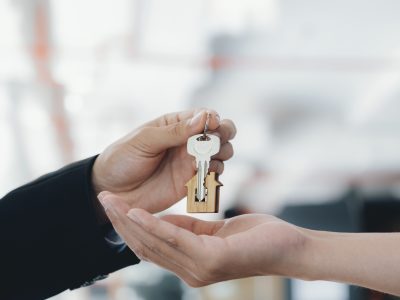 real-estate-agent-holding-key-with-house-shaped-k-2023-11-27-04-59-00-utc-min